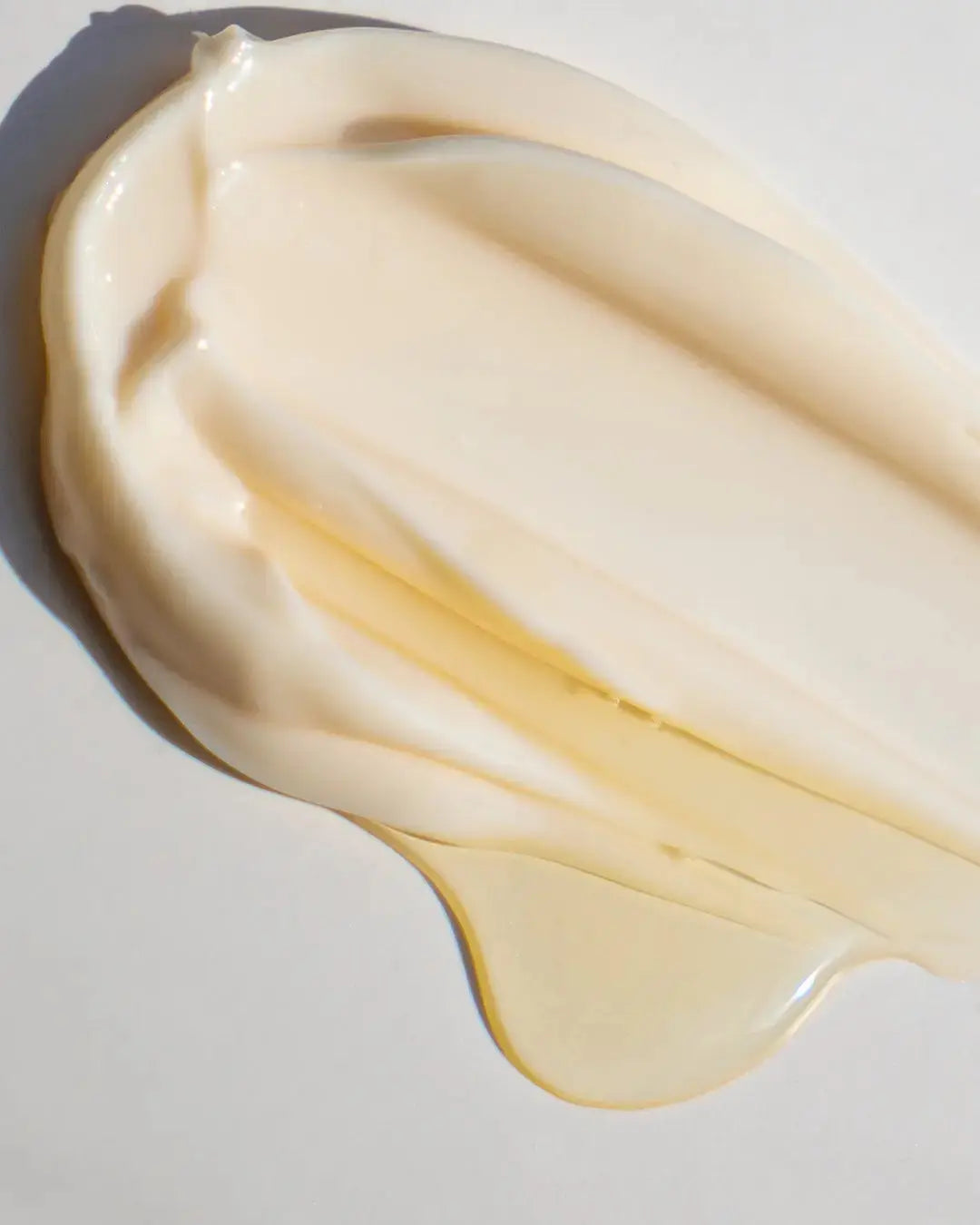 creamy texture of a beige cream on a grey background