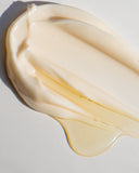 creamy texture of a beige cream on a grey background