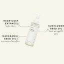 Skincare bottle with labeled ingredients on a white background