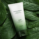 Tube of Matcha Biome cleansing foam on green leaves