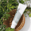 ISNTREE-Mugwort-Calming-Cream in a wooden basket and with mugwort branches