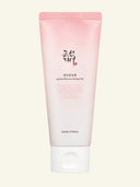 Pink tube of skincare product on a light beige background