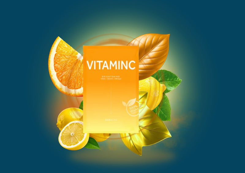 Vitamin C supplement with orange slices, lemon, and leaves on a dark blue background