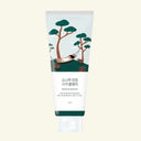 Tube of skincare product with nature-themed design on a light beige background