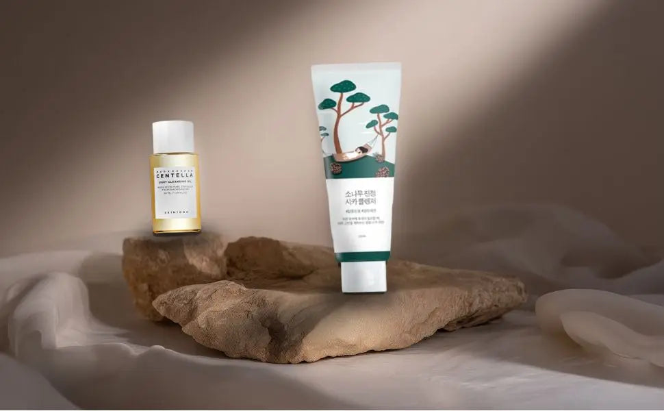 Two skincare products on a stone surface with a neutral background